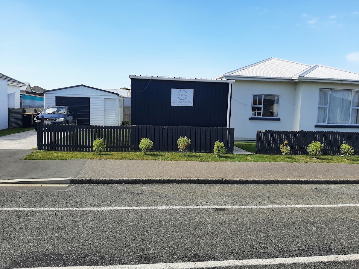 The navy Beauty by Nadia studio behind its picket fence on Conon Street
